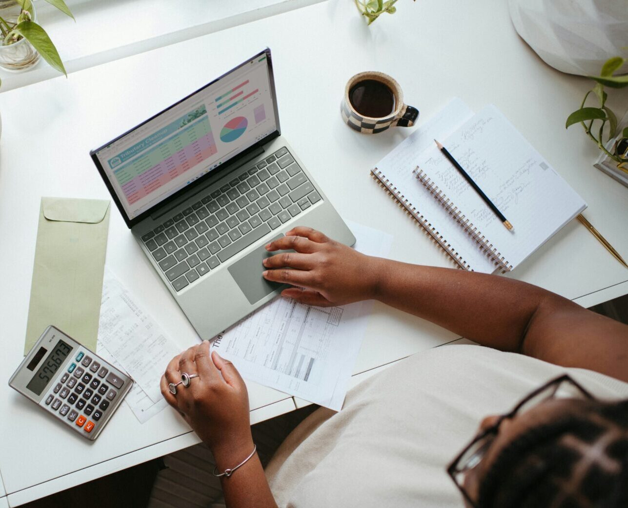 Entrepreneur working on a laptop with a calculator